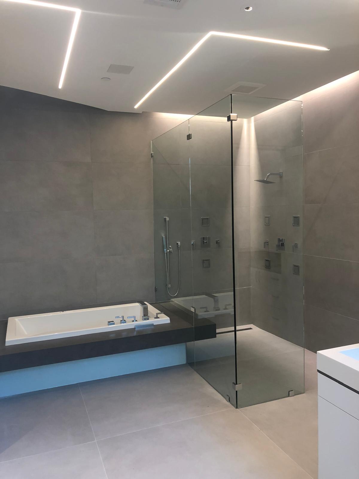 Modern gray bathroom with glass shower